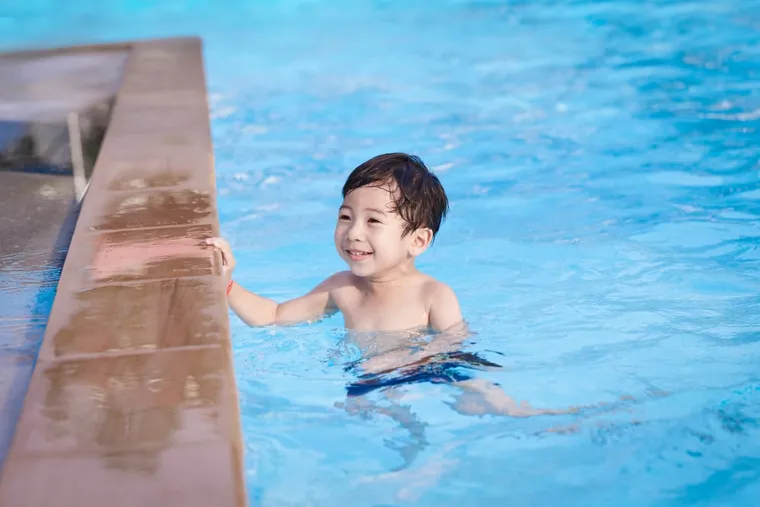 Young child playing in a swimming pool