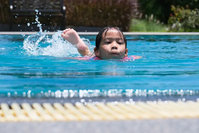 Girl swimming freestyle in a pool