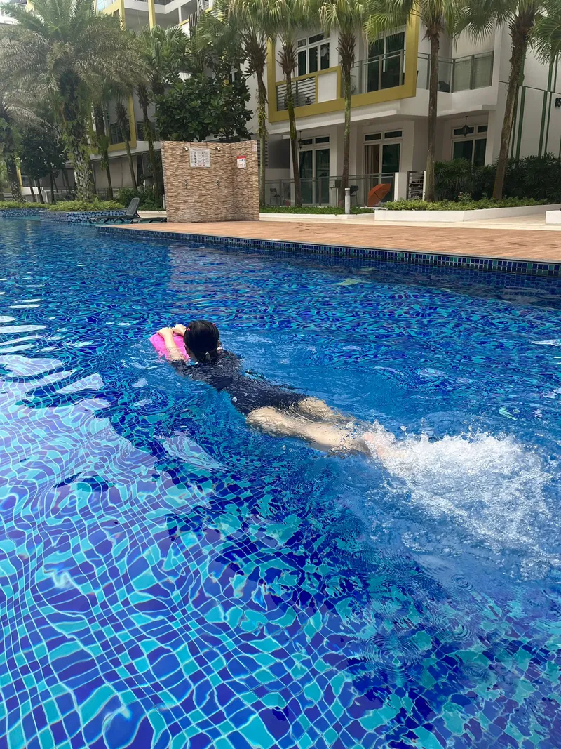 Girl swimming in a condo pool