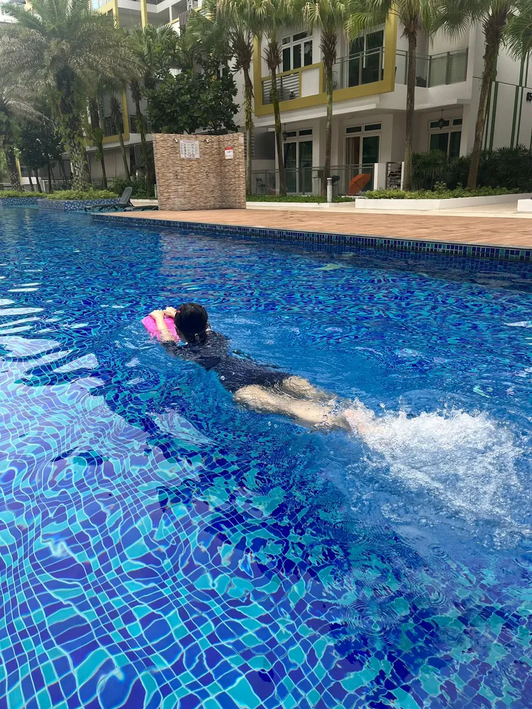 Girl swimming in a condo pool