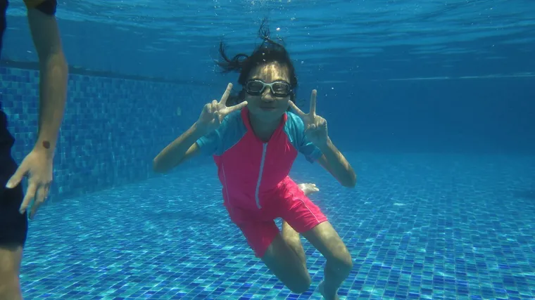 Girl underwater during a private swimming lesson
