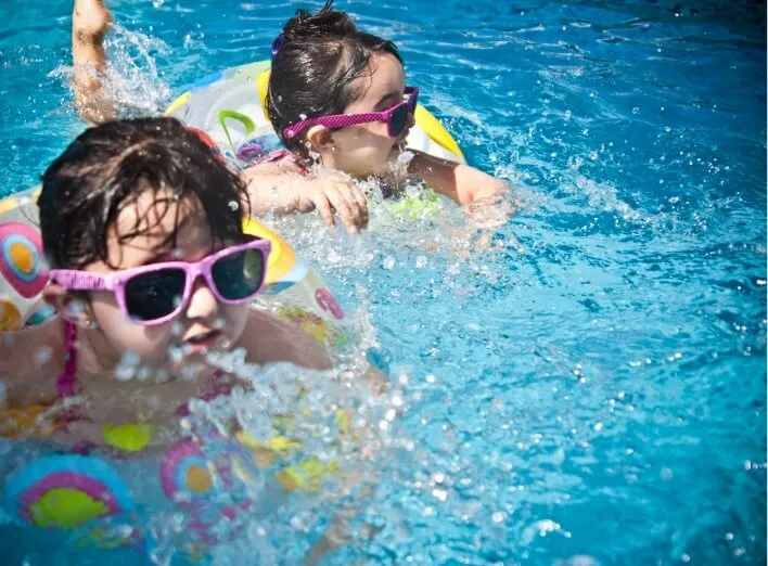 Girls in sunglasses in a pool float