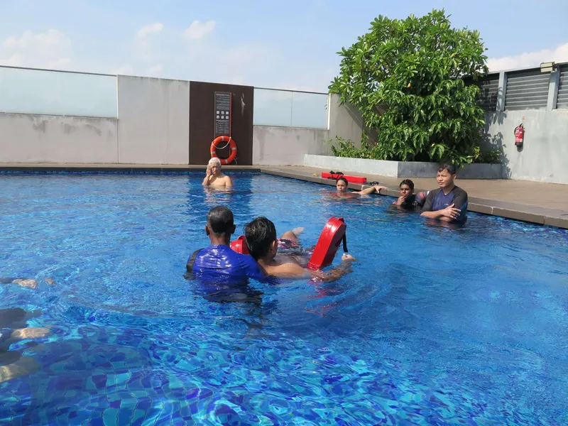 Lifeguard course trainees training with a rescue tube