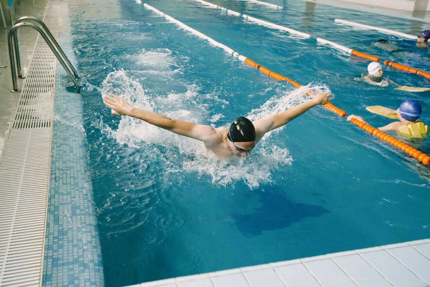 Swimmer doing the butterfly stroke in a lane