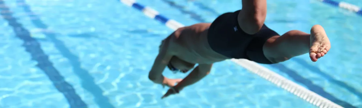 Swimmer diving into a pool