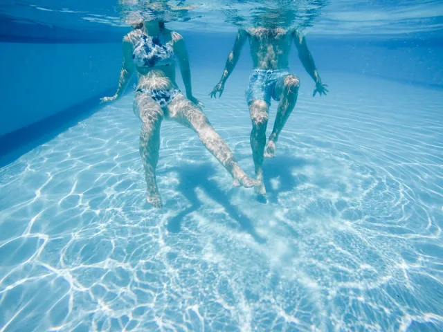 Swimmers sculling, seen underwater