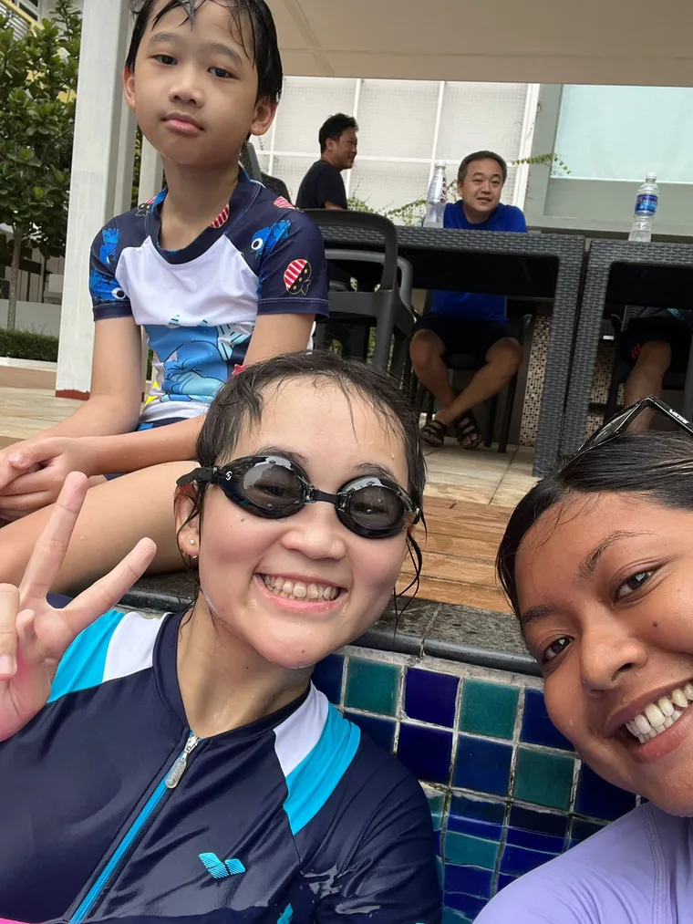 SwimSafe swimming coach with girl students at the poolside