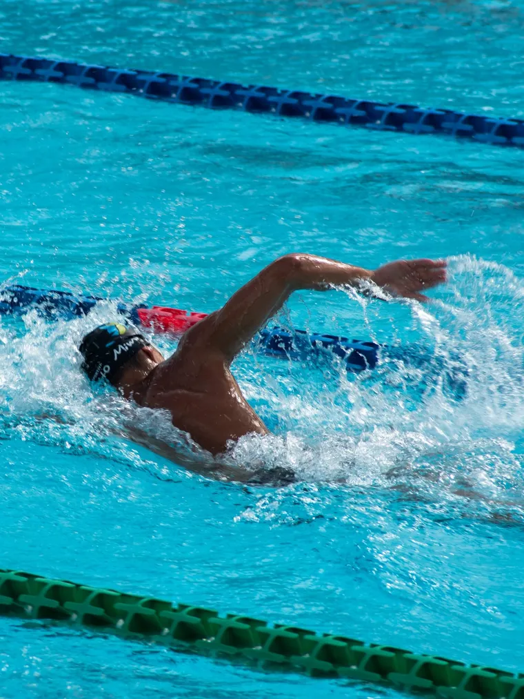 Teenager swimming freestyle in a lane