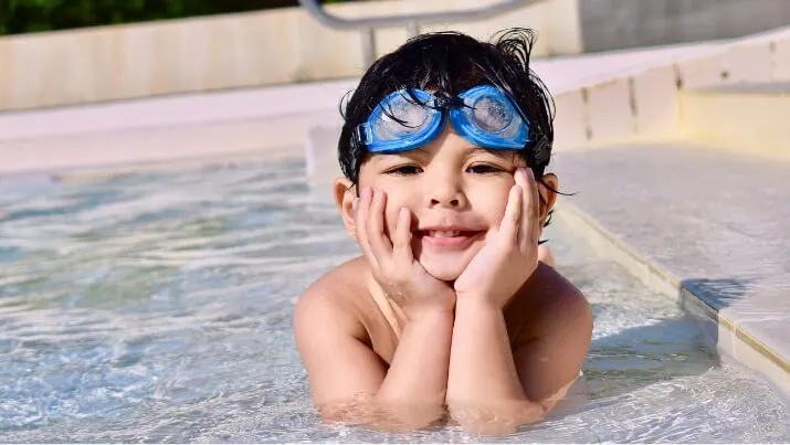 Boy smiling at the pool edge