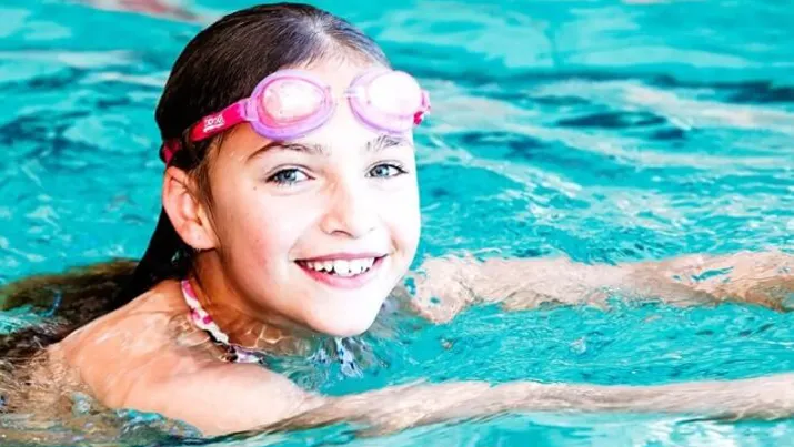 Girl smiling in the pool
