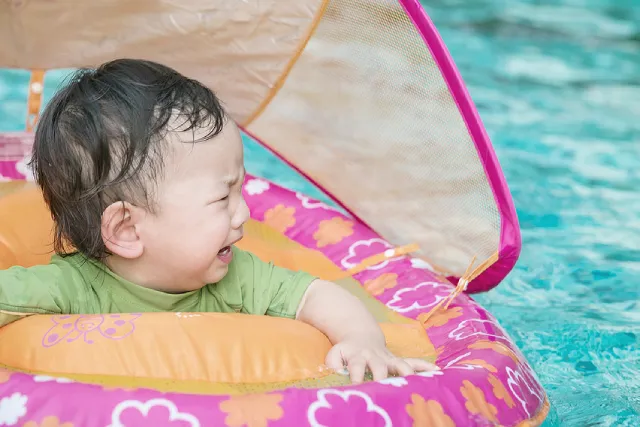 Toddler crying in a pool float