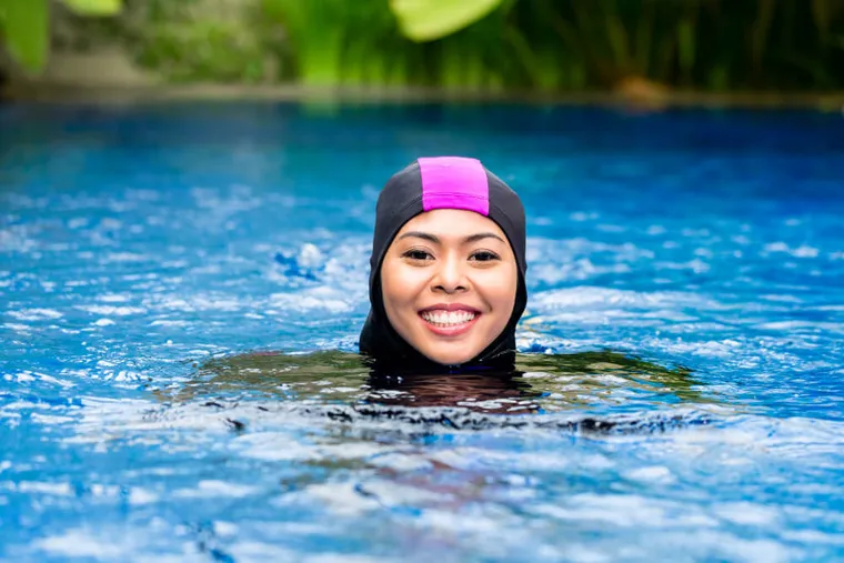 Woman in a burkini in a swimming pool