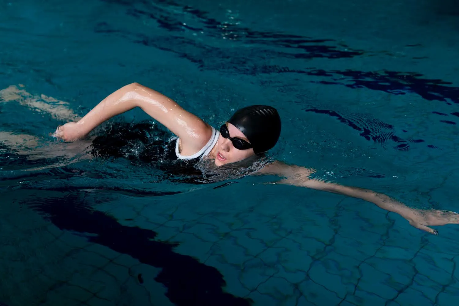 Woman swimming freestyle in a pool