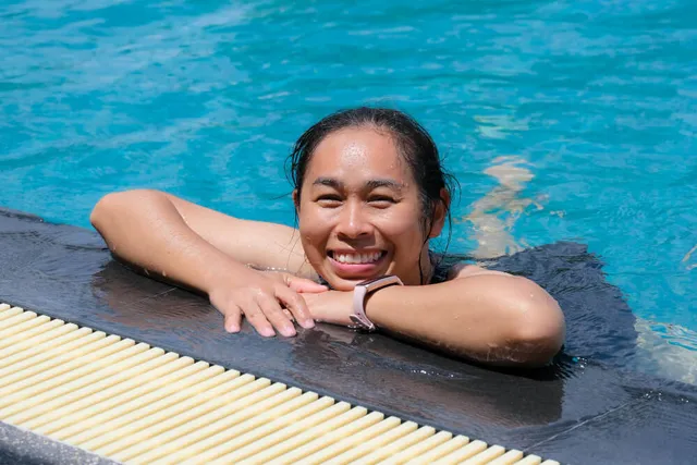 Woman smiling at the pool edge